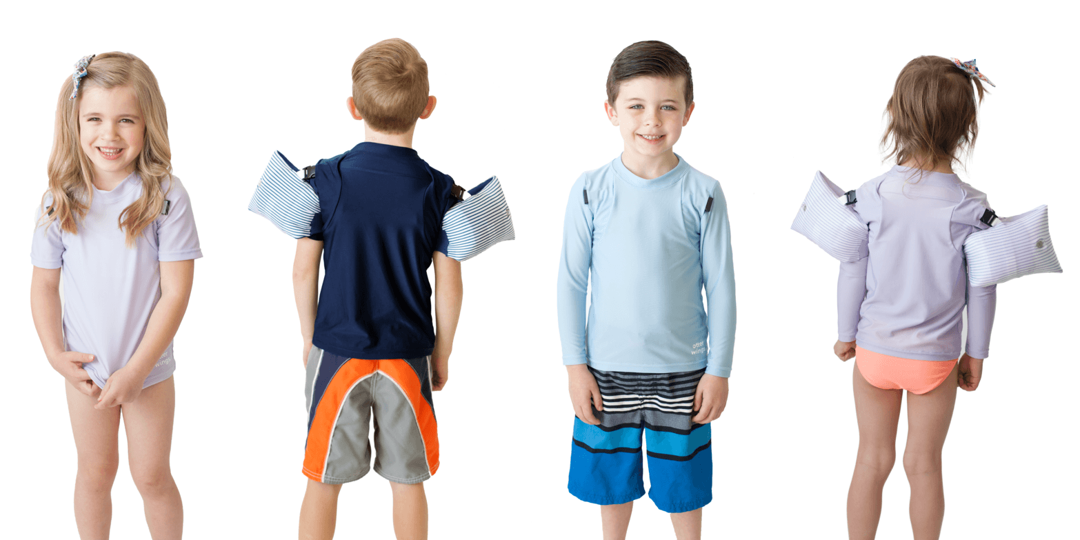 Children modeling Otter Wings swim shirts with attached floatation wings